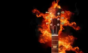 Gitarowa główka otoczona płomieniami, gotowa do zagrania ognistych power chords.