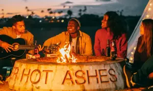 Wszyscy byliśmy harcerzami, gdy płonie ognisko. Tekst na kamieniu "HOT ASHES" przypomina o dawnych czasach.