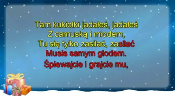 Golec uorkiestra śpiewa "oj, maluśki, maluśki tekst" na tle zimowego nieba z prezentami.